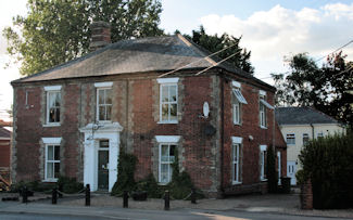 Photograph of the former Railway Tavern. Buildings to the rear were used as the Drill Hall